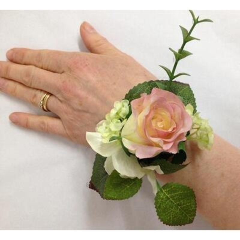 This artificial flower wrist corsage if perfect for Prom Parties or Festivals. The flowers are set onto a cream satin faced snap wristlet so fit any size wrist.